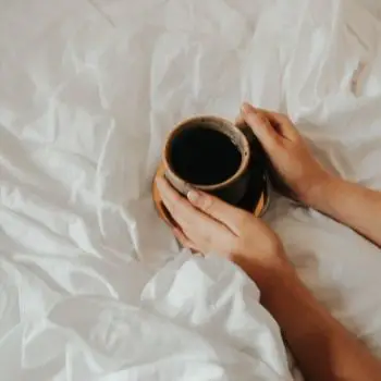 Drinking coffee on a bed