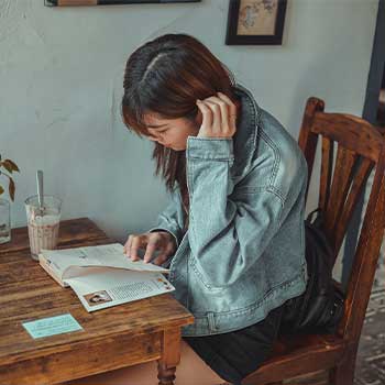 Girl drinking coffee while studying